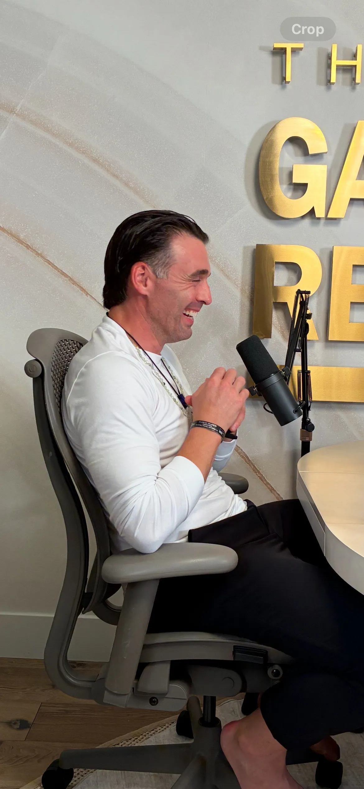 Dominic Luke laughing during The Gabby Reece Show recording